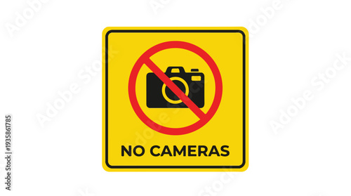 A yellow sign with a red circle and a black camera icon on a white background indicating no cameras allowed.