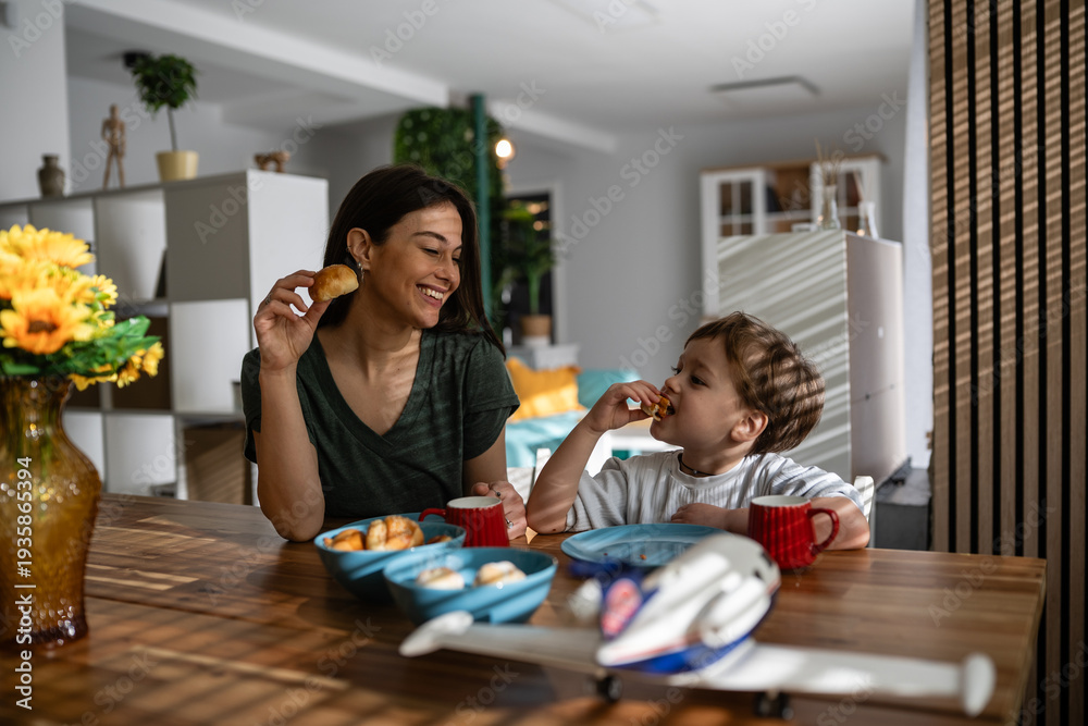 Fototapeta premium Mother and son enjoying family breakfast at home