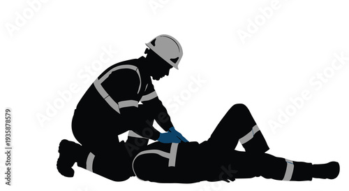 A construction worker kneels to assist a fallen colleague providing first aid in a dramatic silhouette high quality professional