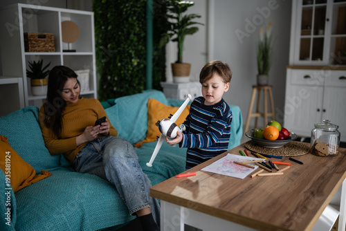 Photos Mother ignoring child playing with toy airplane
