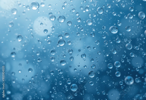 Macro water droplets on glass with blue bokeh background