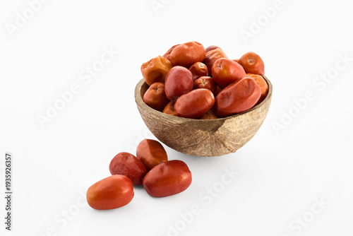 Oleaster silverberry fruits filling a coconut bowl