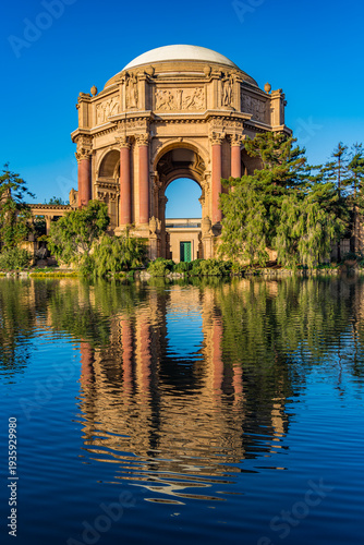 Palace of Fine Arts stands by the water with clear blue sky in San Francisco, California during daylight