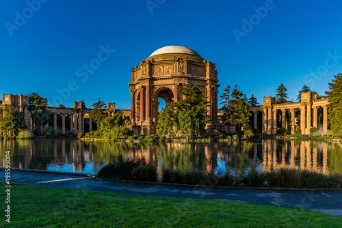 Palace of Fine Arts building stands by water in a park during daylight with clear sky and greenery