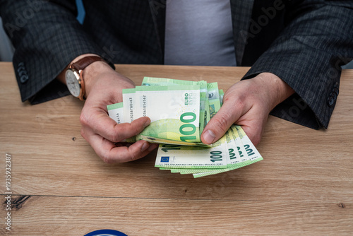 Wallpaper Mural Close up of Man Hands Counting Euro Cash Currency for Corporate Tax Payment or Salary Payout Torontodigital.ca