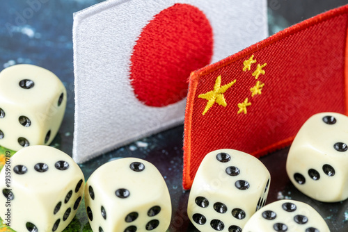 Dice, flags of Japan and China. Business and financial concept. Economic background