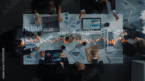 Wallpaper Mural Aerial perspective of a professional business team engaged in data analysis, discussing insights with digital charts and graphs on a conference table in a modern office setting. Raster Torontodigital.ca