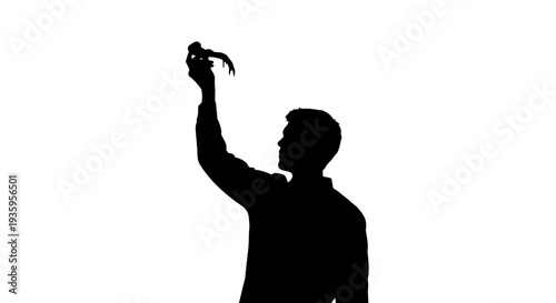 Man holding bird in hand.