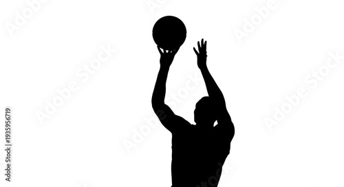 Man playing basketball in silhouette.