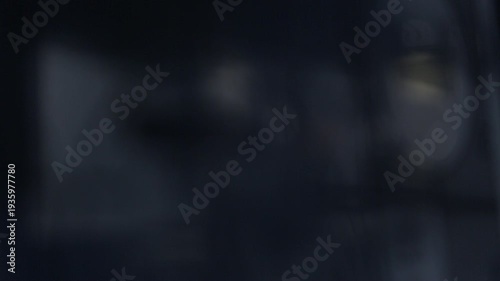 A cinematic close up shot showing a focus pull revealing a classic vintage film camera. The black camera setup features a matte box against a dark studio background.