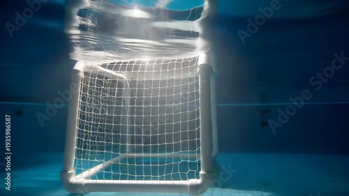 Underwater soccer goal net in a swimming pool with sunlight shining through