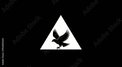 Black silhouette of a bird of prey in flight within a white triangle on a black background.