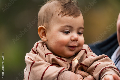Fotografija Baby drooling while being held by an adult