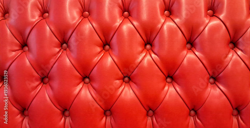 Close-up of red button tufted leather upholstery
