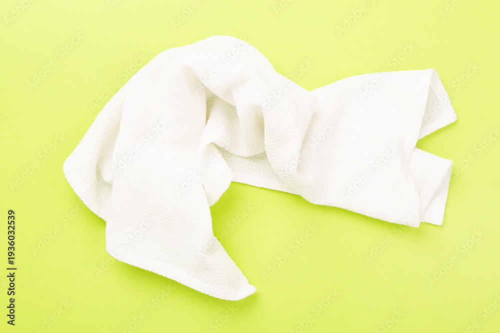 Naklejka premium Kitchen napkin on color background, top view