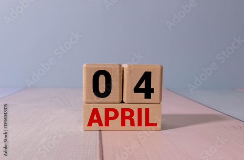 4 April calendar on wooden table with customizable space