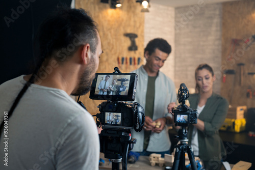 Filmmaker recording couple creating diy content for video tutorial