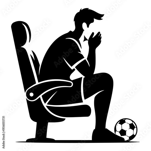 Nervous soccer fan sitting in a chair praying for a goal during an intense game