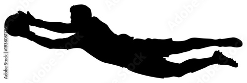 Goalkeeper silhouette diving horizontally to catch the ball during a football match