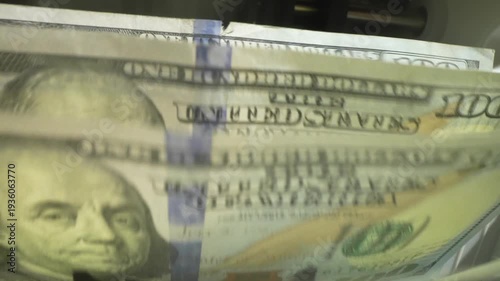 Money counting. Close up currency counting machine counting dollar bills. Machine counter calculates 100 dollars banknotes in slow motion. Closeup currency count machine counting dollar banknotes.