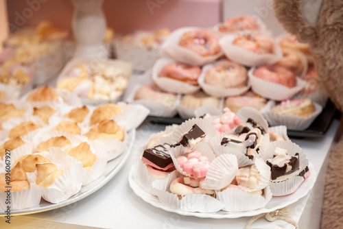 Elegant pink sweet table setup for a birthday celebration featuring beautifully decorated cake pops and delicate desserts in soft pastel tones. 