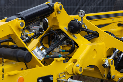 Принти на полотні Close up of modern agricultural trailer hydraulic system with pressure gauge and metal frame components