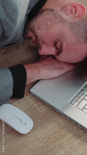 Bored sleepy businessman programmer software developer in formal wear suit falling asleep after routine work on laptop computer at office desk. Exhausted tired freelancer workaholic man. Overworked
