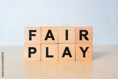 Fotografie Cubes and dice with the word fair play on wooden background