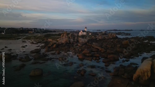 The Pontusval lighthouse, located on a rocky point in northern Finistere in Brittany, aerial footage at sunrise