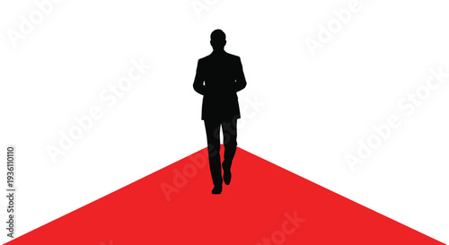 A man walks a red carpet toward the viewer a stark silhouette