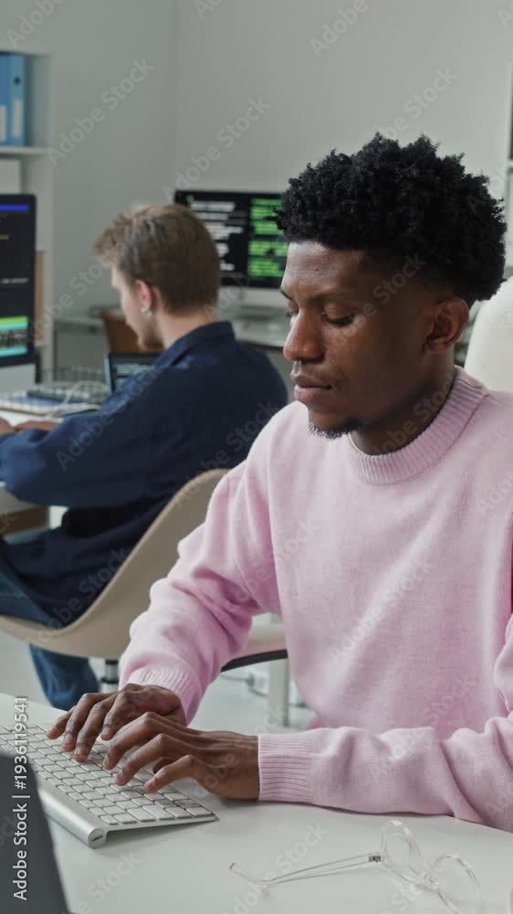 Vertical shot of young adult African American male software engineer ...