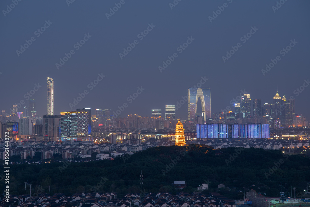 Fototapeta premium Ancient Meets Modern: Suzhou Skyline at Dusk with Historic Pagoda