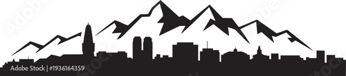 Mountain range silhouette behind city skyline featuring tall buildings and distinctive peaks