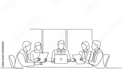Business team discussing documents around a laptop in a meeting room