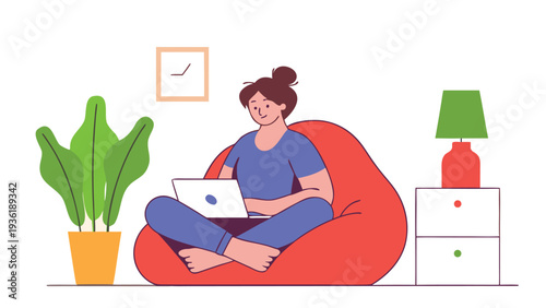 A woman with a hair bun sits cross-legged in a bright red beanbag chair while using a white laptop inside a modern living room setting.