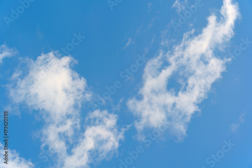 Bilde på lerret Bright blue sky with white wispy clouds background on a clear summer day