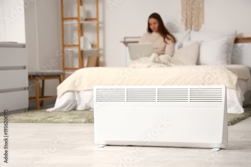 Young woman lying on bed wi...