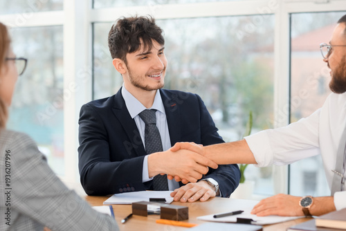 Business men shaking hands ...