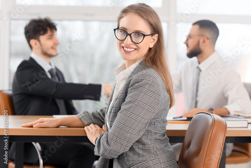 Fotografía Female business mediator working with clients at table in office