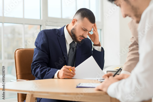 Thoughtful businessman with...