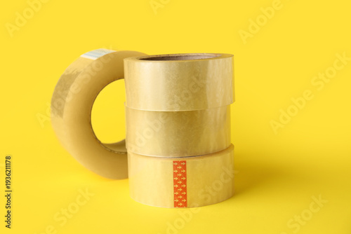 Adhesive tape rolls on yell...