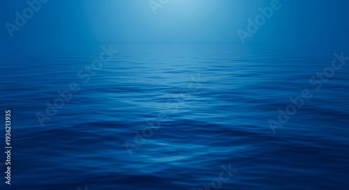 A tranquil, deep blue expanse of water reflects soft light, evoking the profound stillness before oceanic forces awaken and emerge, presence, profound, calm