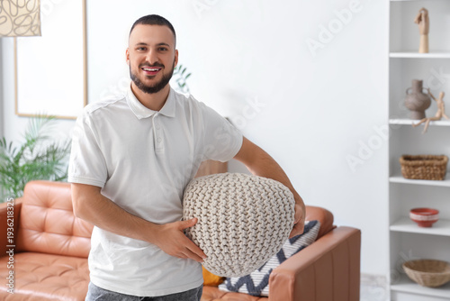 Young man with knitted pouf...