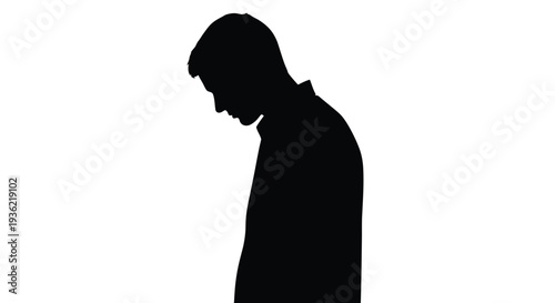 Silhouette of a man with his head bowed appearing contemplative or sad