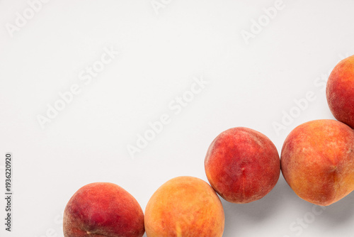 Sweet ripe peaches on beige...