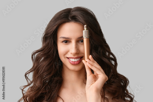 Happy young woman with masc...