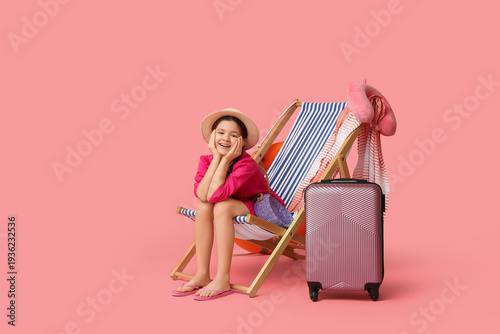 Cute girl with suitcase sit...