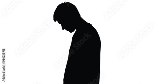 Silhouette of a man with his head bowed appearing somber and introspective
