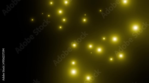 黒背景の上でたくさんの黄色の粒子が次々降り落ちる