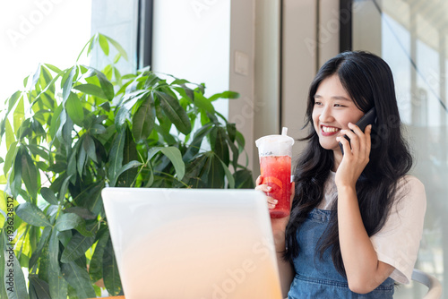A Chinese beauty drinking milk tea while working in a milk tea shop